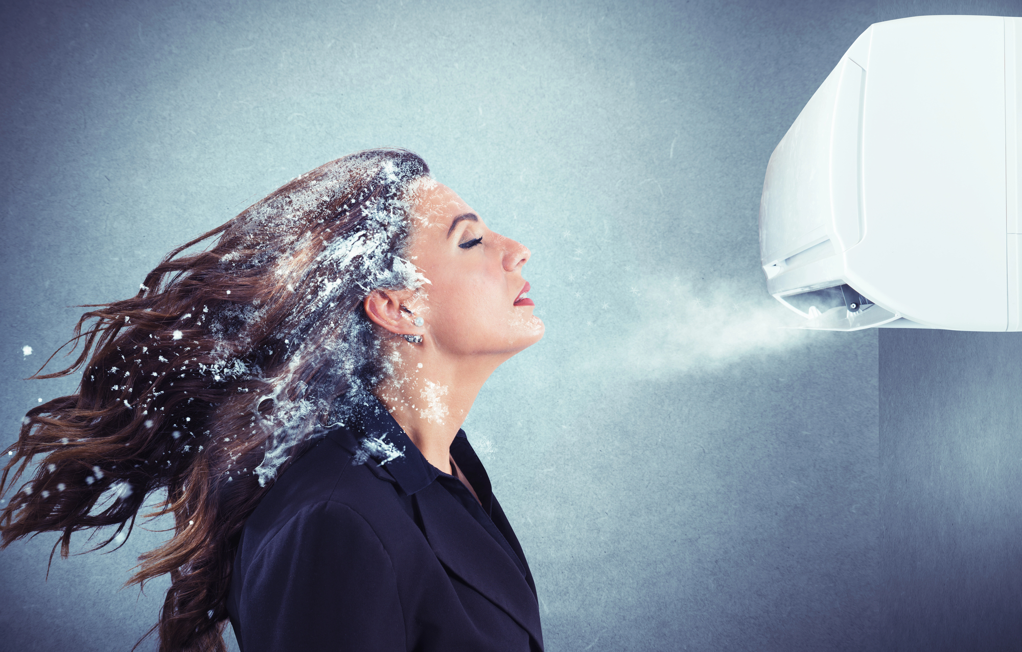 Woman with freezing air blowing on her.